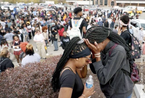 People embrace outside the school. — courtesy Twitter