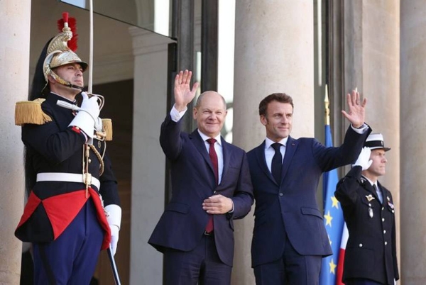 French President Emmanuel Macron, right, welcomes German Chancellor Olaf Scholz at the Elysee Palace in Paris, Wednesday. — courtesy Twitter