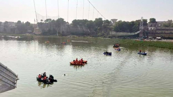 Rescue boats scour for survivors and bodies in the Macchu River following a newly-renovated suspension bridge in the western Gujarat state in India collapsed on Sunday.