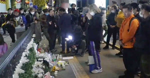 People pay tribute to victims near the scene of a deadly accident in Seoul, South Korea, Sunday, after Saturday’s Halloween festivities. — courtesy photo