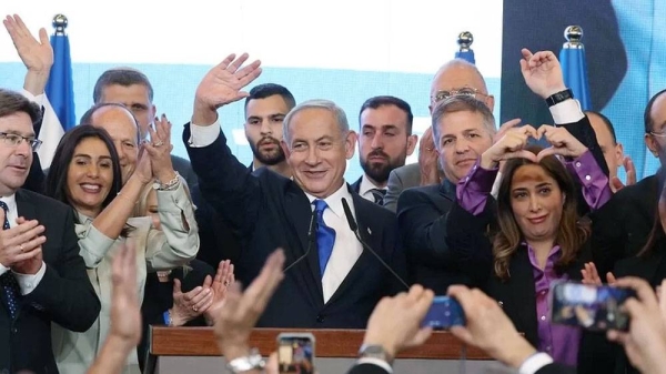 Benjamin Netanyahu acknowledges the cheering supporters at Likud headquarters. 