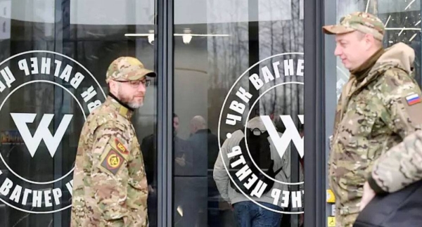 Visitors wearing military camouflage at the entrance of the ‘PMC Wagner Centre’, the private military group’s HQ, during the official opening, St Petersburg, Friday. — courtesy Olga Maltseva / AFP