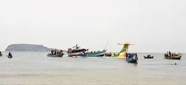 Rescuers in boats are seen around the tail fin of a crashed Precision Air passenger aircraft on the shores of Lake Victoria in Bukoba, Sunday. — courtesy AYO TV