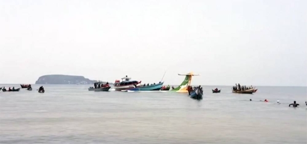 Rescuers in boats are seen around the tail fin of a crashed Precision Air passenger aircraft on the shores of Lake Victoria in Bukoba, Sunday. — courtesy photo