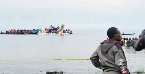 Rescuers in boats are seen around the tail fin of a crashed Precision Air passenger aircraft on the shores of Lake Victoria in Bukoba, Sunday. — courtesy photo