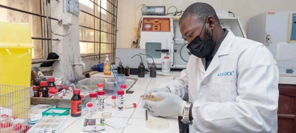 A doctor reviews a sample at a microbiology laboratory in a teaching hospital in Nigeria. — courtesy WHO/Etinosa Yvonne