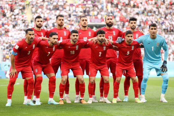 The 11 Iranian players stood impassively and grim-faced as their anthem rang out around the Khalifa International Stadium. (@FIFAWorldCup)