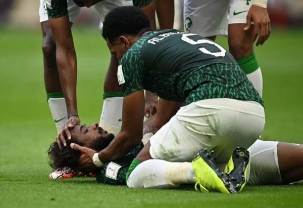 File photo of the Saudi National team before the start of their match against Poland carrying the shirt of defender Yasser Al-Shahrani in a supportive gesture.