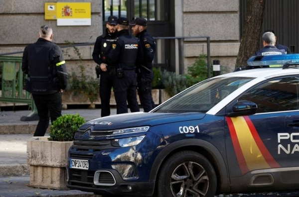 Police officers stand outside Spain's defense ministry after suspected explosive devices hidden in envelopes were mailed to the building, officials said