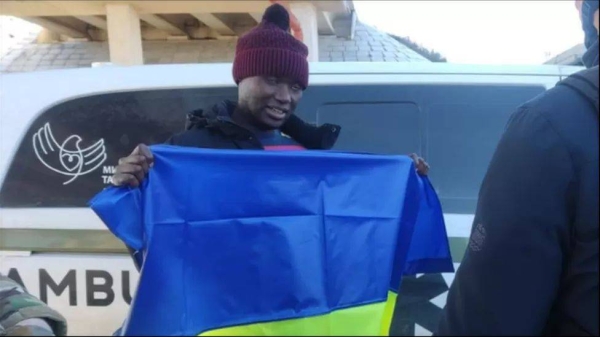 Murekezi seen holding a Ukrainian flag