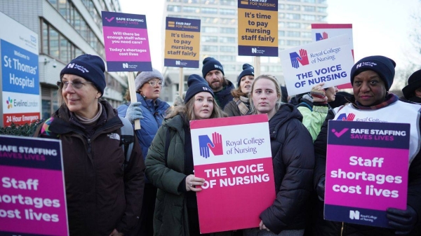 Members of the Royal College of Nursing stand on a picket line outside St. Thomas' Hospital in London on Thursday.