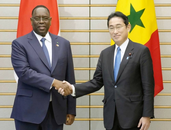 Japanese Prime Minister Fumio Kishida, right, and Senegalese President Macky Sall shake hands ahead of talks at the prime minister's office in Tokyo on Monday. — courtesy photo Kyodo