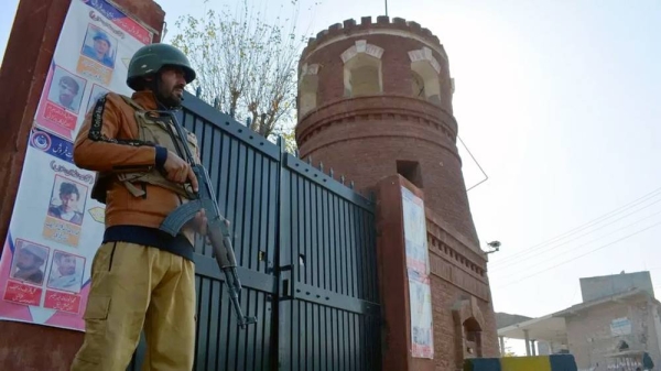 A Pakistani security official guards a gate on the road leading to the police station. — courtesy Getty Images