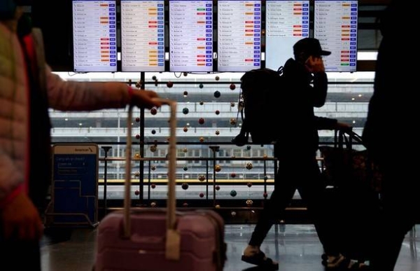 Travelers arrive for their flights at O'Hare International Airport in Chicago on December 22