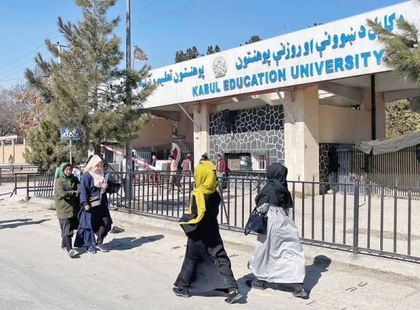 Students walk along a street near the Kabul University after it was reopened in Kabul on Feb. 26, 2022.