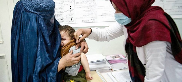 The Taliban de facto authorities have issued several orders rolling back the rights of women and girls in Afghan society. In this file photo, a health worker cares for a young boy in Parwan Province. — courtesy WFP/ Massoud Hossaini