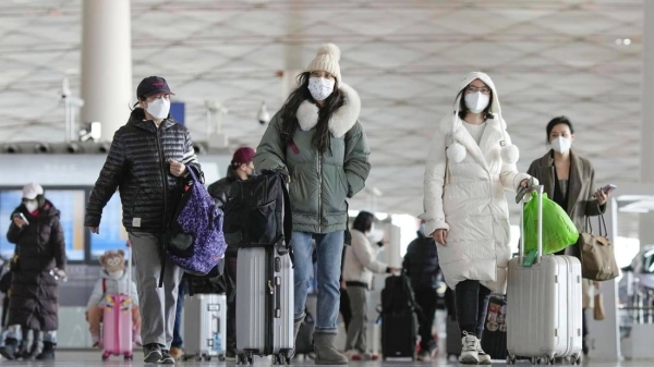 Passengers at the departure hall in Beijing's international airport on December 27.