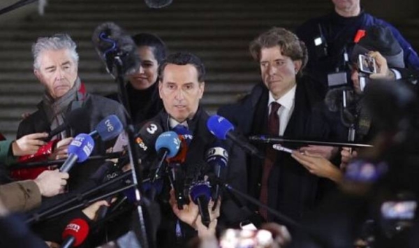 Lawyers for former European Parliament Vice-President Eva Kaili, Michalis Dimitrakopoulos, right, and Andre Risopoulos, left, speak with the media on Dec. 22 