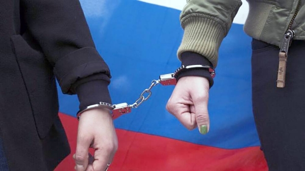 

Two women wear a handcuff and a Russian flag as they attend a protest against the jailing of the Russian opposition leader Alexei Navalny in Berlin, Germany, April, 2021. — courtesy Markus Schreiber/Copyright 2021 The AP.