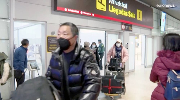 A passenger arriving from China is tested for COVID-19 at the Roissy Charles de Gaulle airport, Paris.