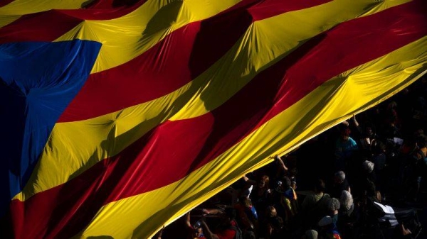 Protesters hold esteladas or independence flags as they take part in a demonstration during the Catalan National Day in Barcelona, Spain, Sunday, Sept. 11, 2022.