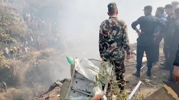 Rescuers and crowds gather at Nepal plane crash site. — courtesy screenshot