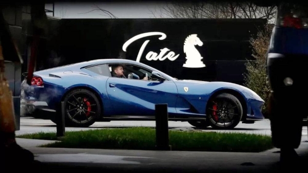 A Romanian police officer was seen behind the wheel of a Ferrari at Andrew Tate's property. — courtesy EPA