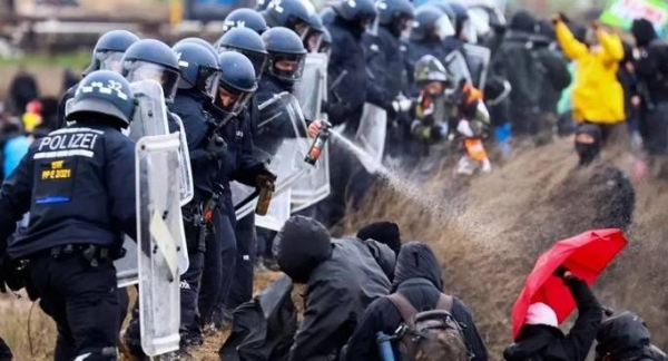 Police use water cannon to disperse activists during a protest against the expansion of a German coal mine in Luetzerath.