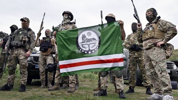 The Dzhokhar Dudayev Chechen volunteer battalion hold the flag of the Chechen Republic of Ichkeria during a training session in the Kyiv region on August 27, 2022. — courtesy Genya Savilov/AFP