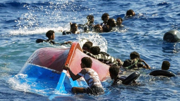 Migrants swim next to their overturned wooden boat during a rescue operation by Spanish NGO Open Arms at south of the Italian Lampedusa island at the Mediterranean sea, 2022. — courtesy Francisco Seco/ AP.