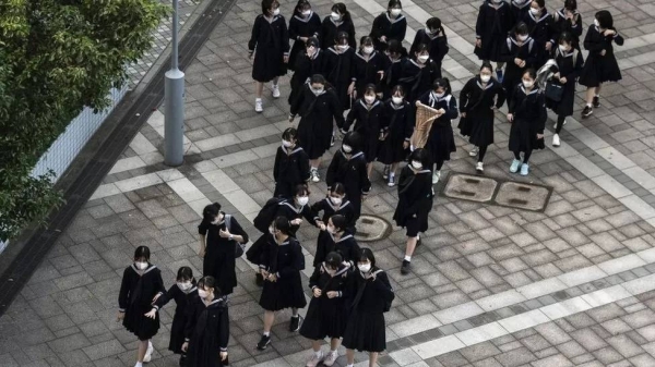 Schoolgirls are pictured after school in Tokyo on 4 November 2021