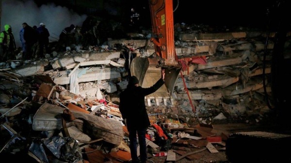 A rescue team works on a collapsed building in Osmaniye, Turkey, on Monday.
