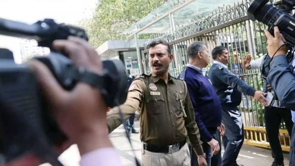 Police officers stand outside a building having BBC offices, where income tax officials are conducting a search, in New Delhi, India. — courtesy Reuters