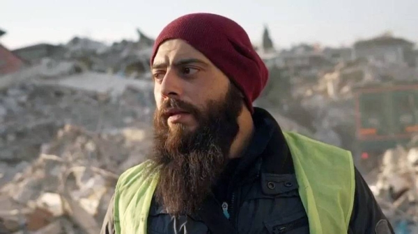 Ali, a Syrian, stands in front of collapsed buildings in Antakya, Turkey. Ali dug his fiancee Viam out of the rubble of her collapsed block of flats,