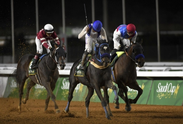 Emblem Road (right), last year's the Saudi Cup champion and the runner-up  Country Grammar (center) in this file photo.