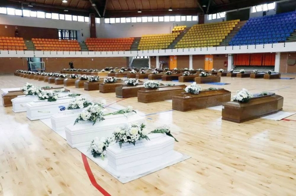 Coffins containing people who died in a migrant shipwreck lie in a sports hall in Crotone, Italy, on Tuesday. — courtesy Reuters