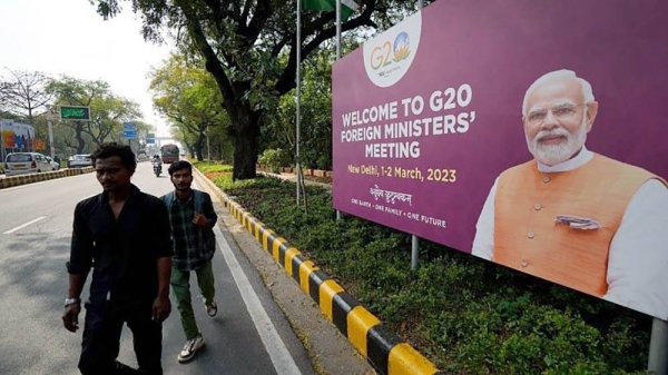 
Commuters walk past a banner with Indian Prime Minister’s Narendra Modi photograph welcoming delegates of G20 foreign ministers meeting, in New Delhi, India, Wednesday. — courtesy AP