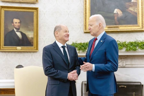 President Joe Biden listens as German Chancellor Olaf Scholz speaks during a meeting in the Oval Office of the White House in Washington.