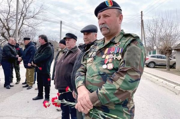 Vlad Untila attends a ceremony in the village of Molovata Noua.