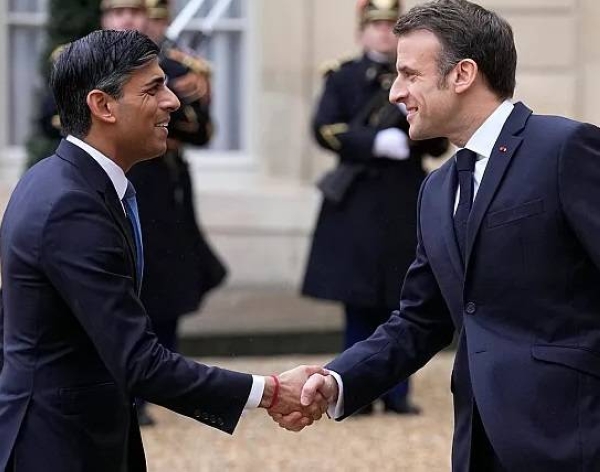 French President Emmanuel Macron shakes hands with Britain's Prime Minister Rishi Sunak at the Elysee Palace in Paris on Friday