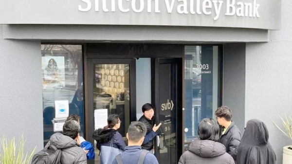 A worker (C) tells people that the Silicon Valley Bank (SVB) headquarters is closed on Friday in Santa Clara, California. — courtesy Getty Images