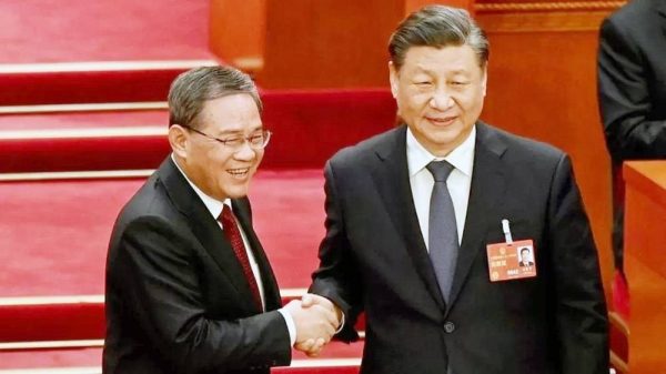 China’s President Xi Jinping (R) shakes hands with newly-elected Premier Li Qiang. — courtesy Getty Images