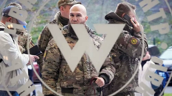 File photo shows visitors wearing military camouflage stand at the entrance of the ‘PMC Wagner Centre’, St Petersburg. — courtesy AP