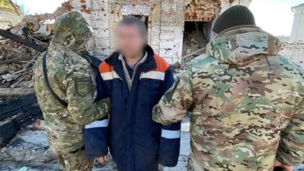 The Russian soldier (center) is detained by two members of Ukraine's armed forces in Kupiansk, Ukraine.