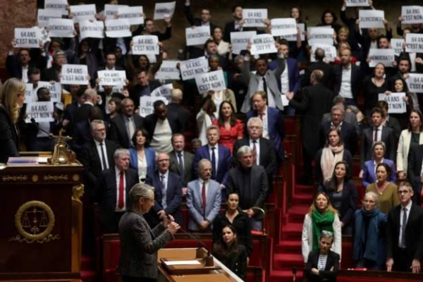 Opposition politicians held up signs protesting the plans to raise the pension age and sang La Marseillaise, the French national anthem.