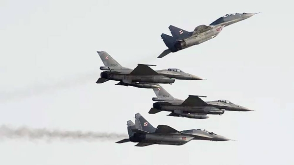 
Two Polish Air Force Russian made MiG 29’s fly above and below two Polish Air Force US made F-16’s fighter jets during the Air Show in Radom, Poland, on Aug. 27, 2011. — courtesy AP