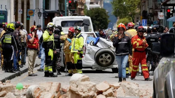 Emergency services survey the damage in Cuenca, following the powerful 6.7 magnitude earthquake in southern Ecuador. — courtesy Reuters