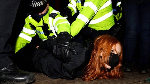 A woman attending the Sarah Everard vigil in south London on March 13, 2021 is arrested by police