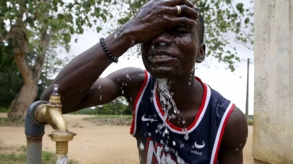 A man washing his face at a tap in Ivory Coast this week