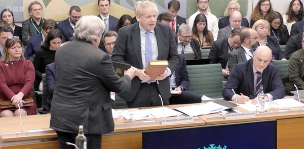 
Former British PM Boris Johnson takes an oath on the Bible before being grilled in the Partygate saga in London on Wednesday.